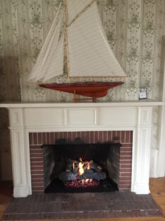 cross timbers log set into wood burning fireplace