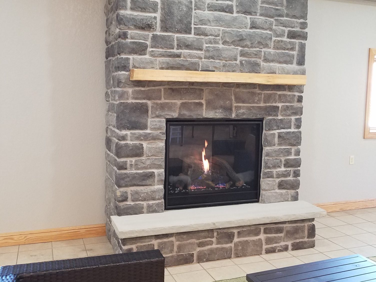 Installation of clean face direct vent fireplace and stonework