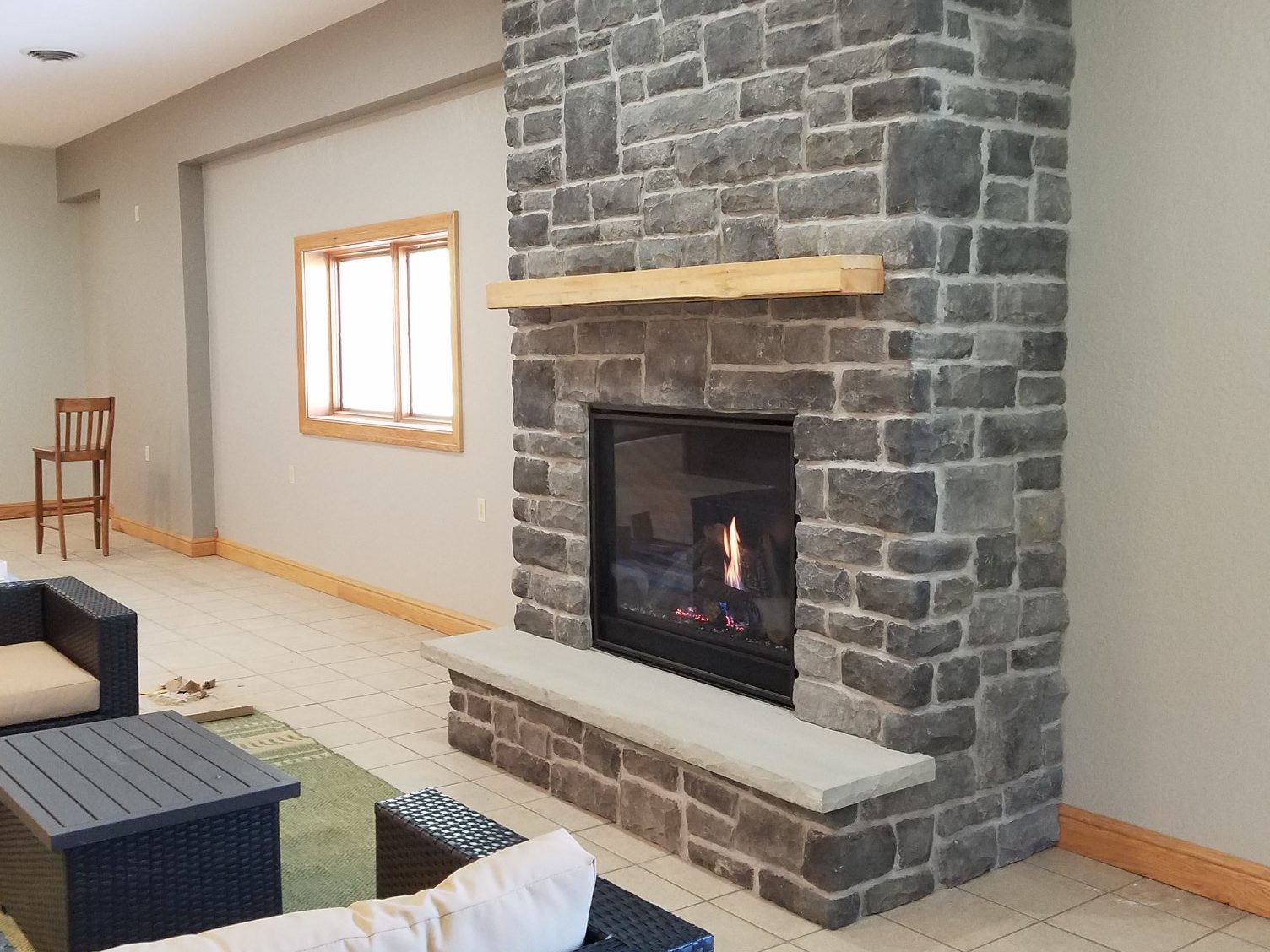 Installation of clean face direct vent fireplace and stonework