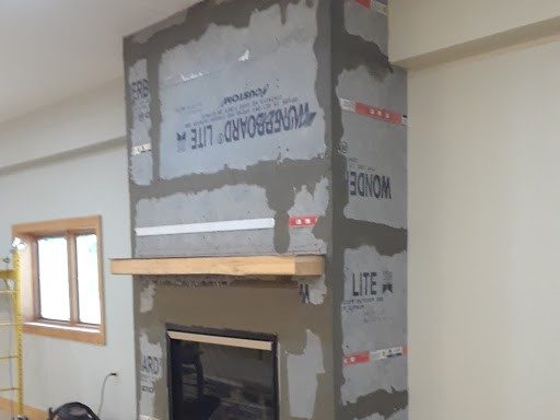 Installation of clean face direct vent fireplace and stonework
